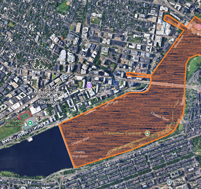 Arial photo of the Charles River, with spread of bacteria colored in orange.