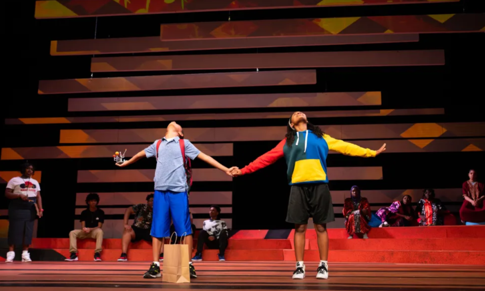 Scene from the olay Kufre N’ Quay, in which the titular characters are holding hands.