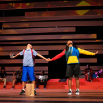 Scene from the olay Kufre N’ Quay, in which the titular characters are holding hands.