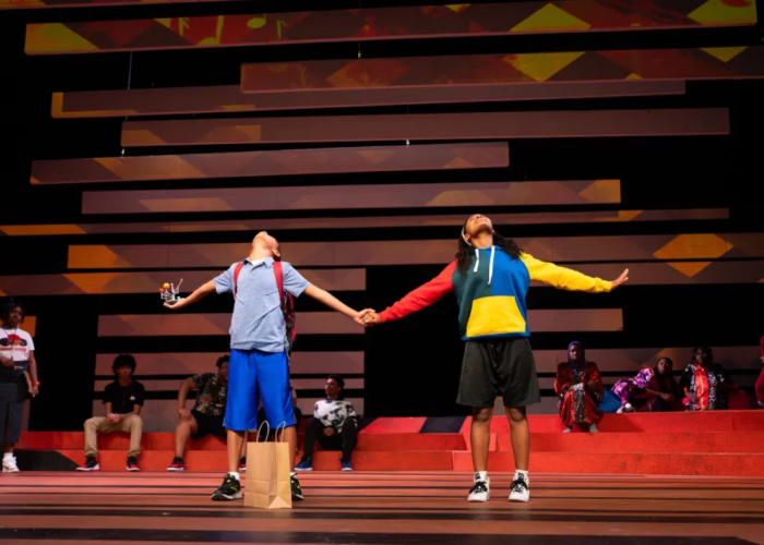 Scene from the olay Kufre N’ Quay, in which the titular characters are holding hands.