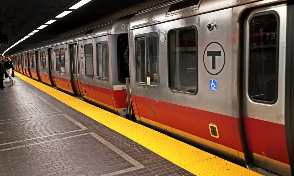 Red line train pulling up to a station