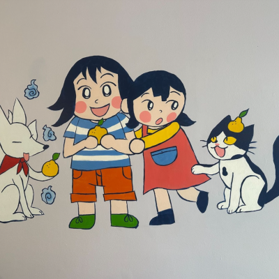 Mural of a white fox, two smiling children, and a black and white cat.