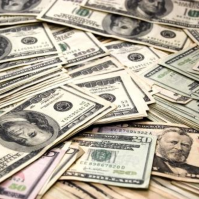 Photograph of a lot of dollar bills.