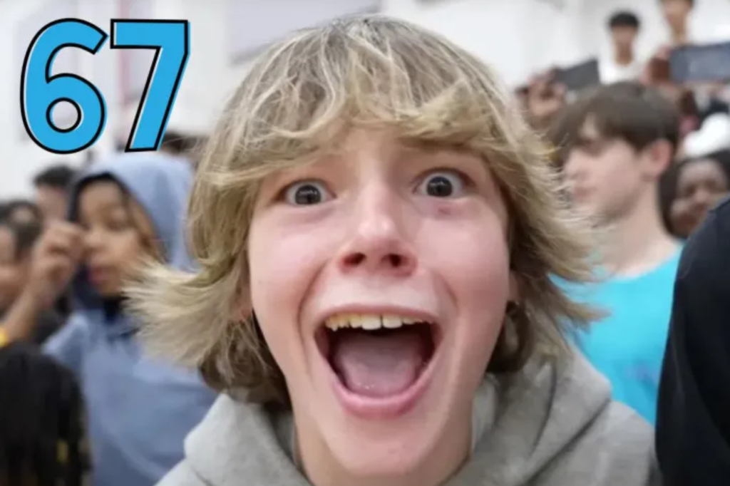 Video screenshot where a white tween boy with shaggy hair opens his mouth wide.